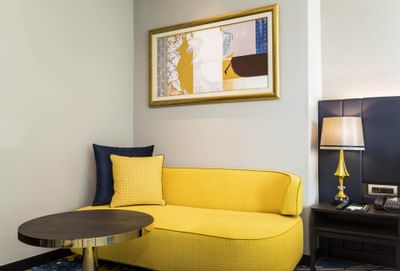 A couch in Grand Deluxe City View Room at Chatrium Hotel