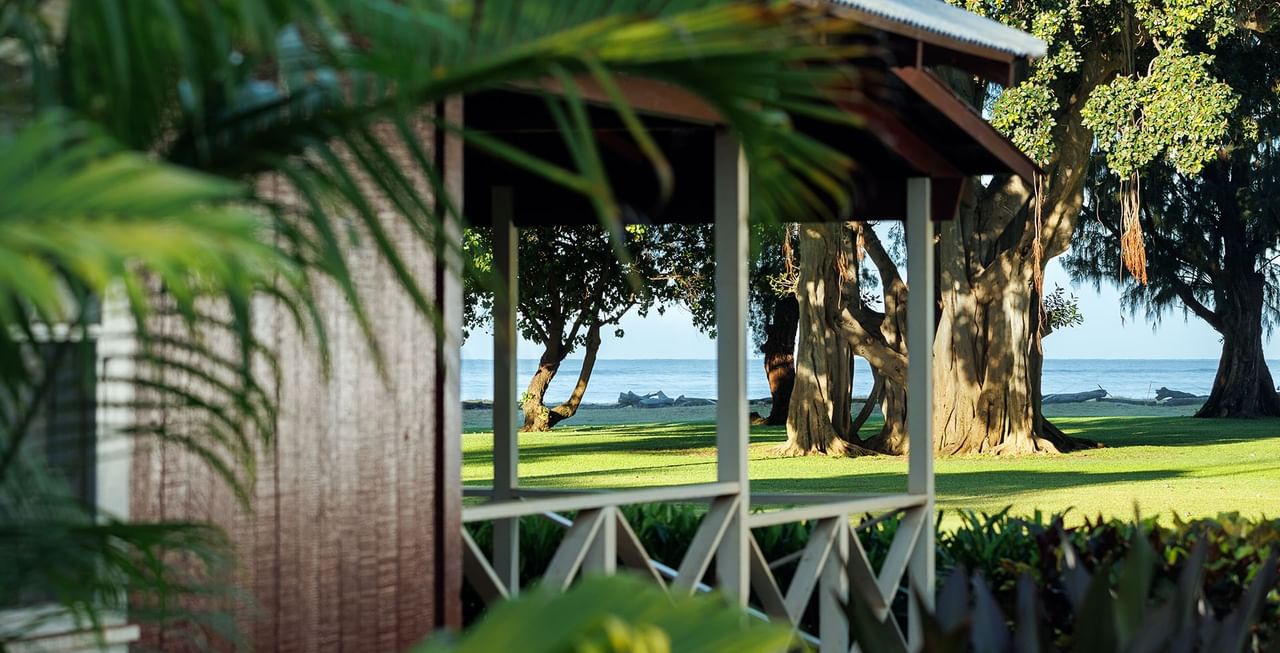 Cottage exterior with trees and ocean view