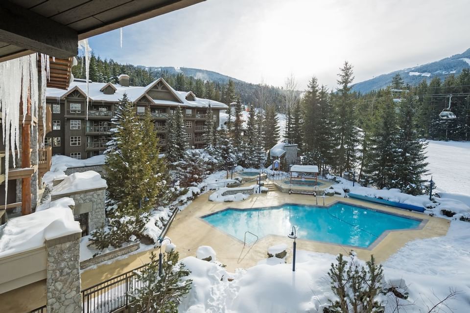 pool at resort surrounded by snow