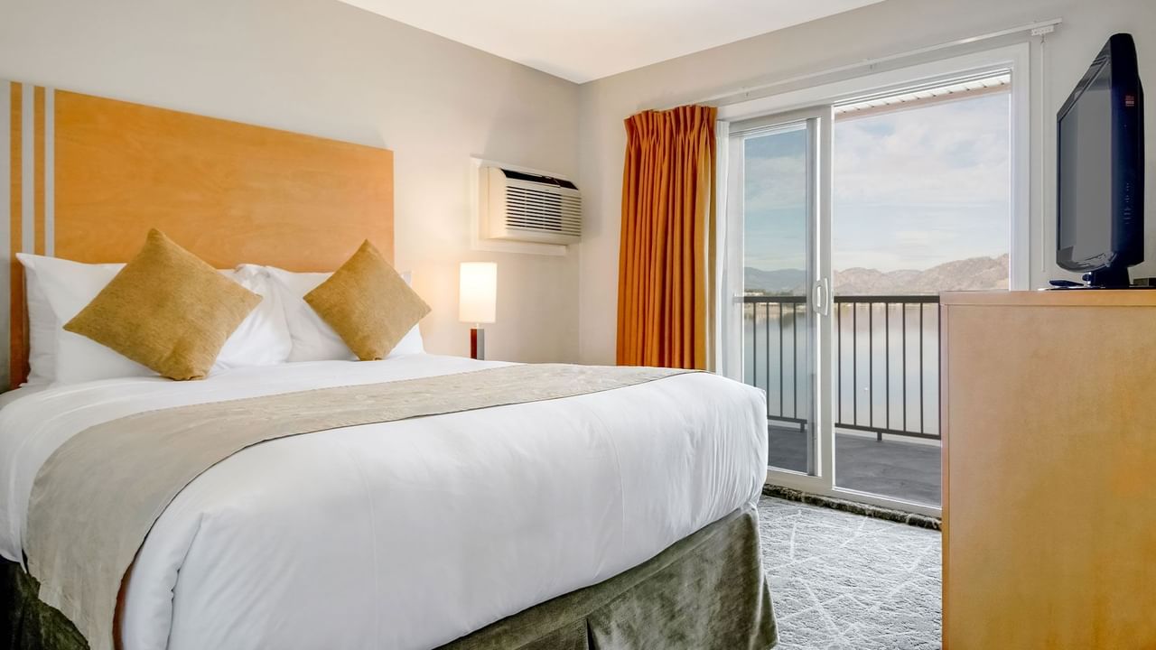 Bedroom with lake view and TV
