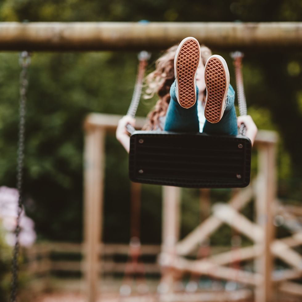 Close-up of a girl on a swing near Falkensteiner Hotels