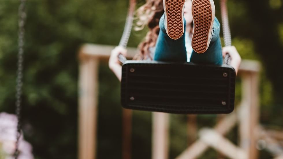 Close-up of a girl on a swing near Falkensteiner Hotels