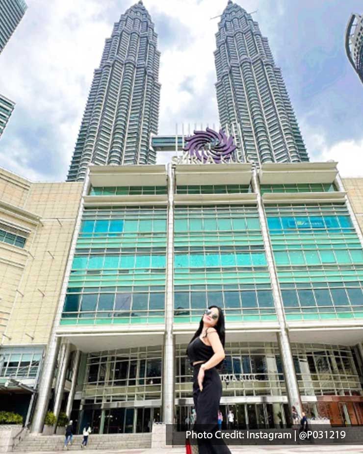 Girl posing in front of The Petronas Twin Towers entrance, a well-known attraction near Imperial Lexis Kuala Lumpur