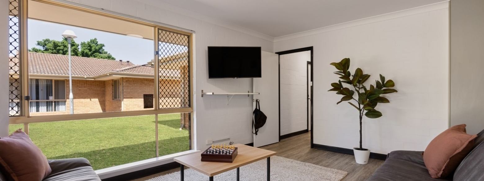 Living room with two couches, a coffee table, and a television at UniLodge at Curtin University - Vickery House in Bentley.