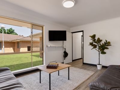 Cozy living room with couch, coffee table, and TV at UniLodge at Curtin University - Vickery House.