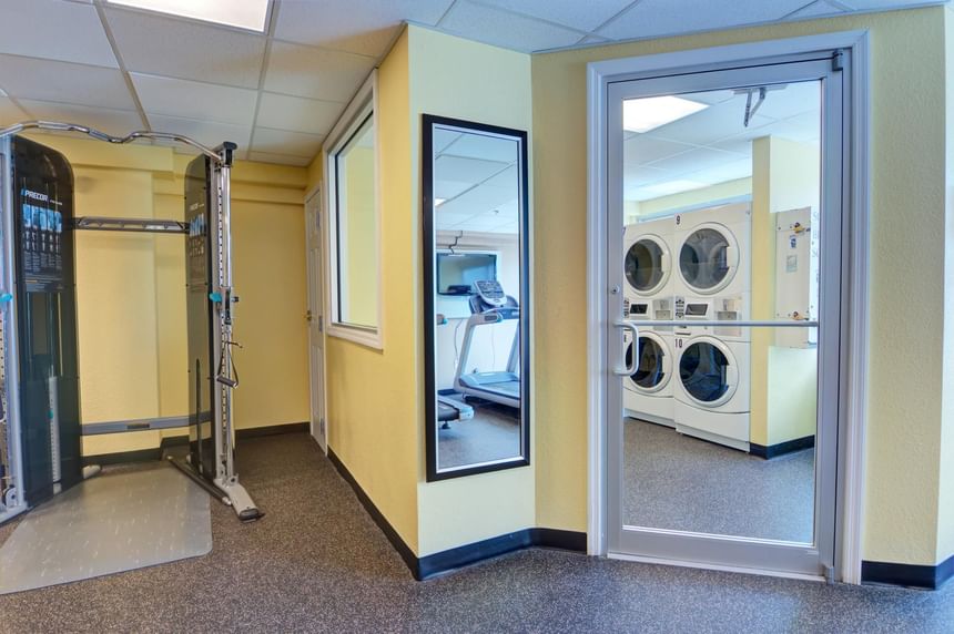 Laundry area featuring washing machine and dryer next to Fitness Center at The Barrymore Hotel