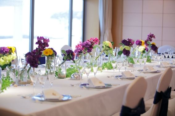 Elegant wedding table set up with floral decor in an event room at Grand Park Otaru