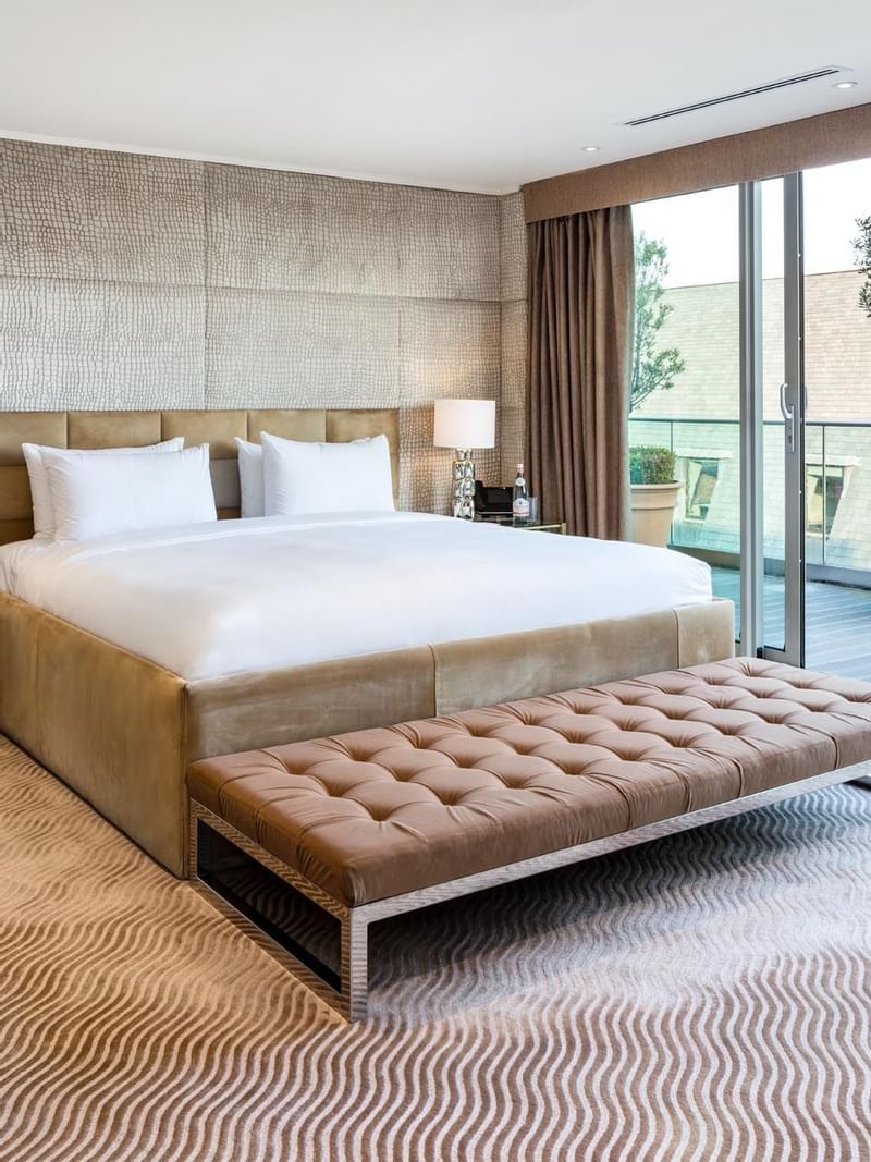 Interior of a bedroom with king bed at May Fair Hotel London