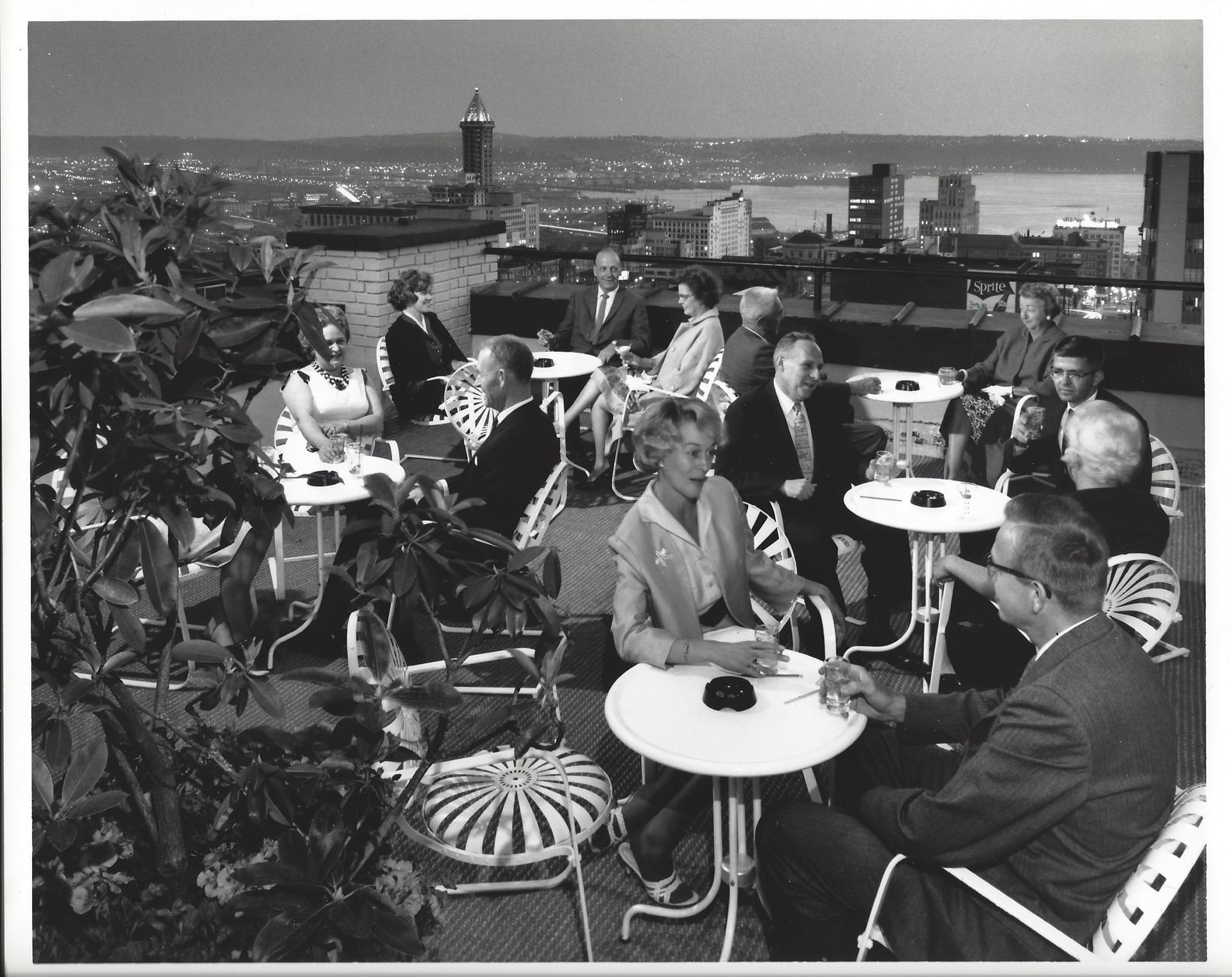 Vintage image of people enjoying drink on rooftop terrace of Top of the Town at Hotel Sorrento