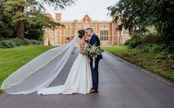 Bride and groom outside of Easthampstead Park in Berkshire