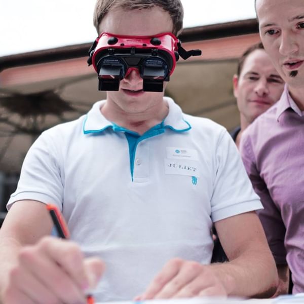 A person writing with inversion goggles at Falkensteiner Hotels