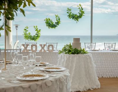 Wedding venue set up with round tables and simple white décor