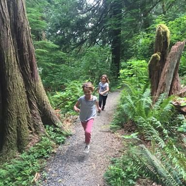 Two kids are running on the trails at Alderbrook Woods