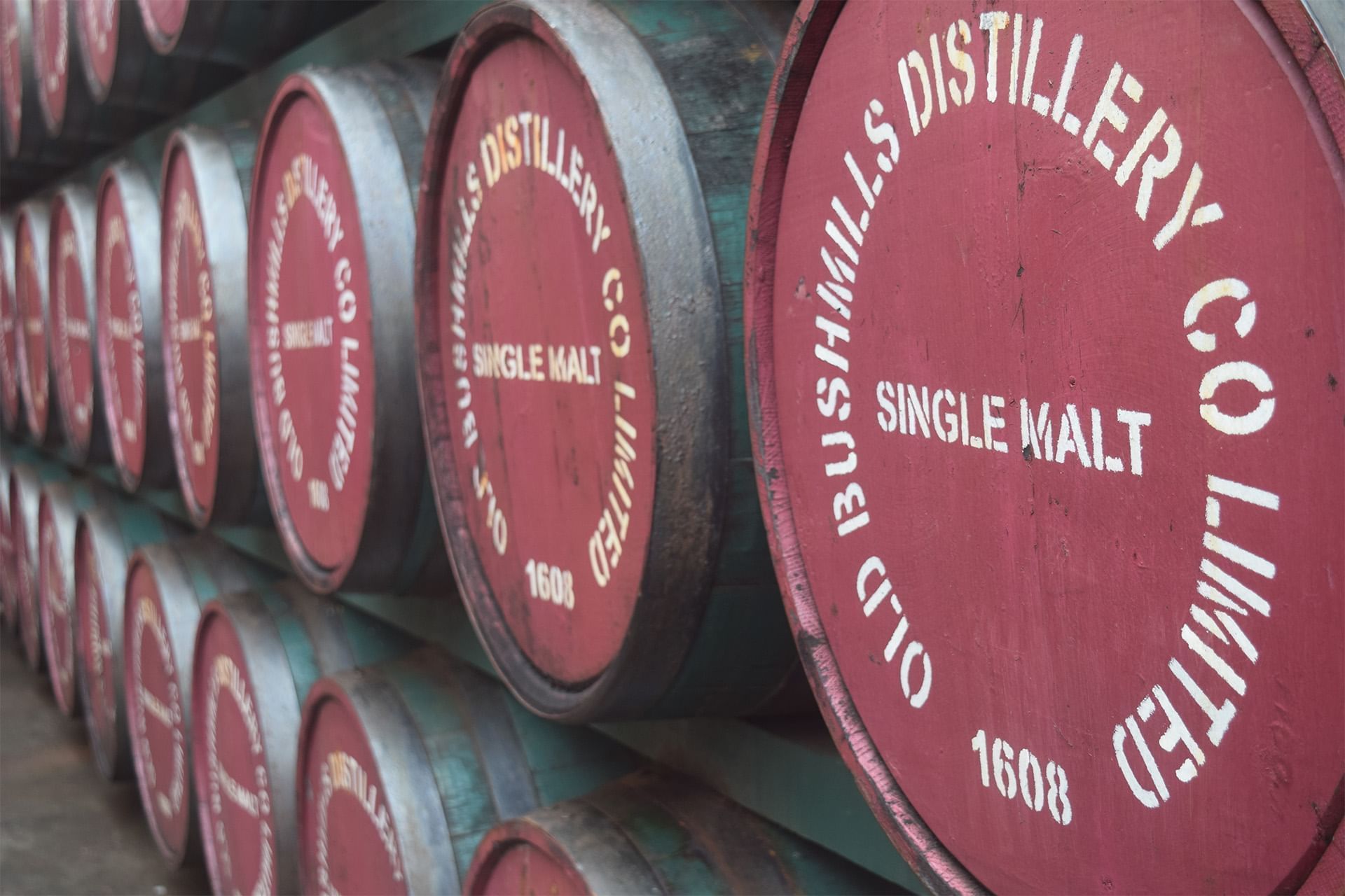 Close-up of stacked whiskey barrels in Old Bushmills Distillery near Dunluce Lodge