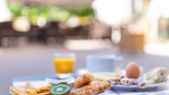 Close-up of breakfast served outdoors at The Originals Hotels