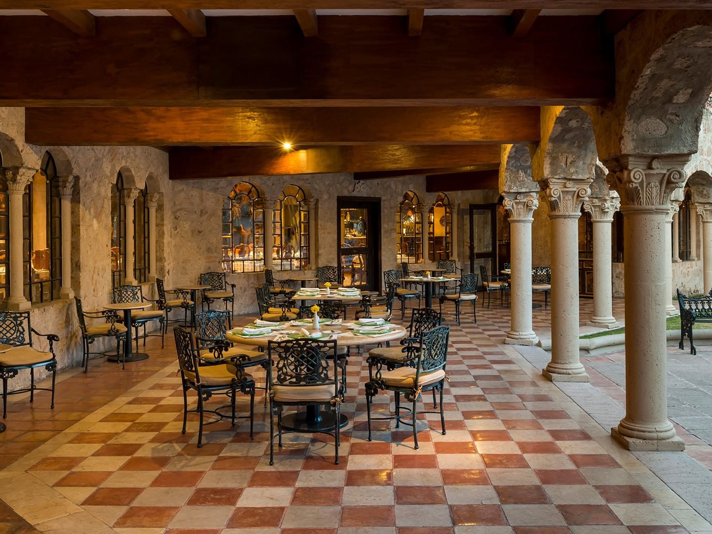 Los Murales restaurant with checkered floors and stone columns at Quinta Real Aguascalientes