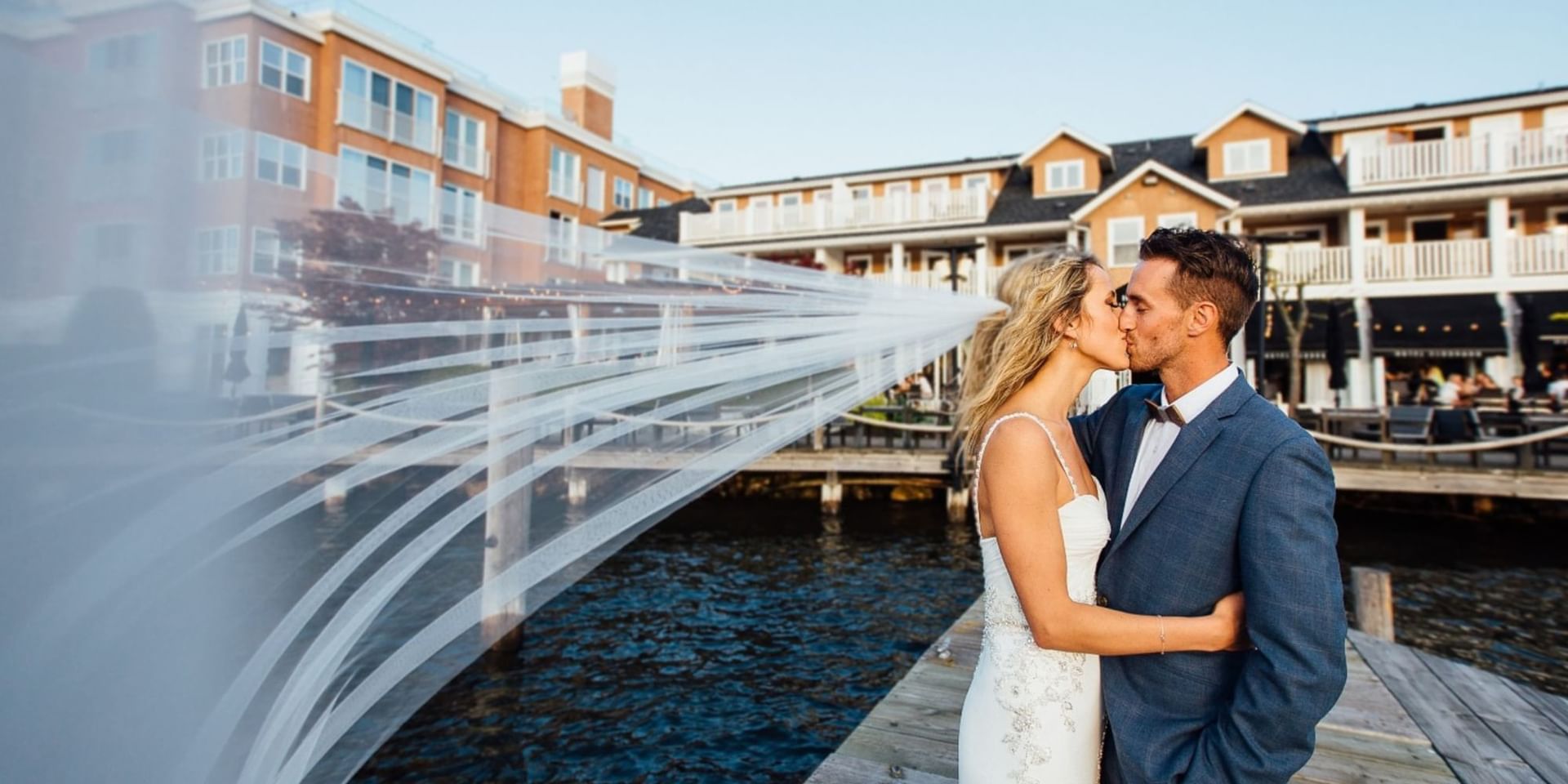 A wedded couple kissing with a hotel view at Hotel Eldorado