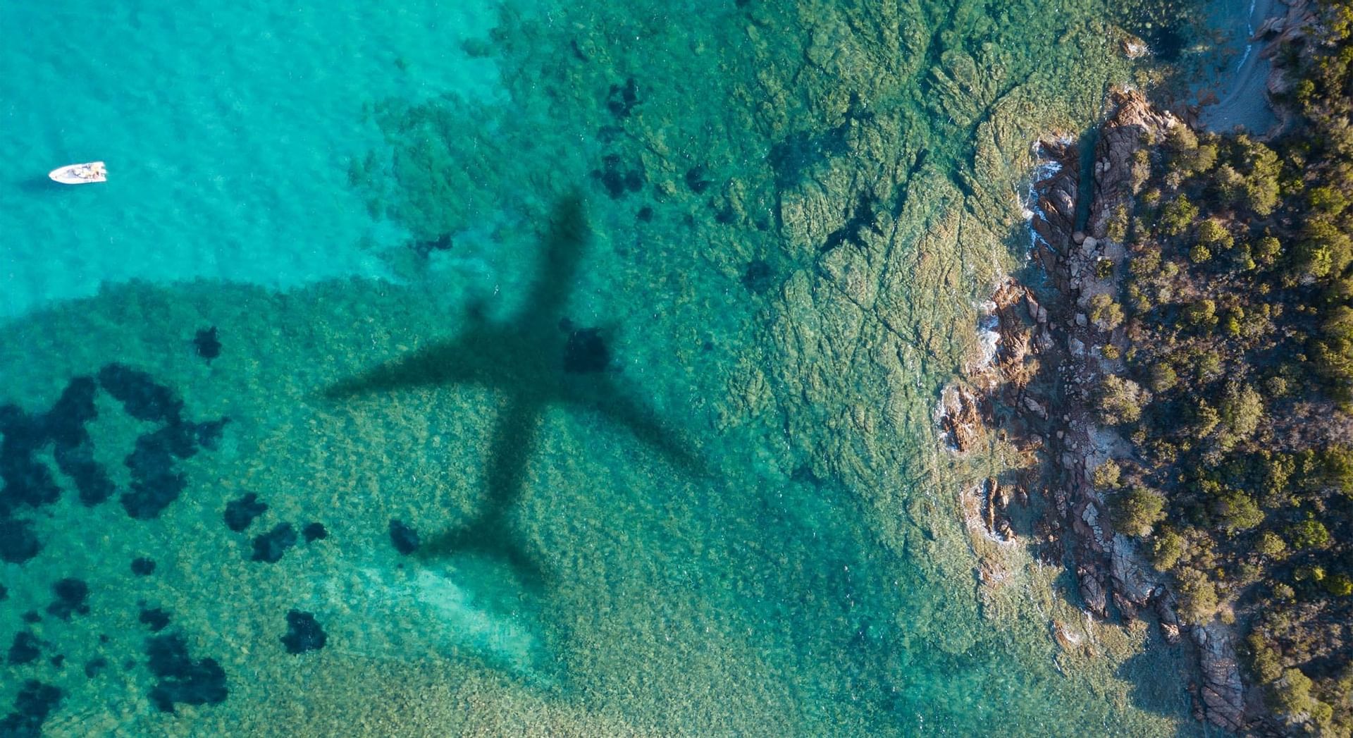 A shadow of a plane on the shallow sea at Falkensteiner Hotels