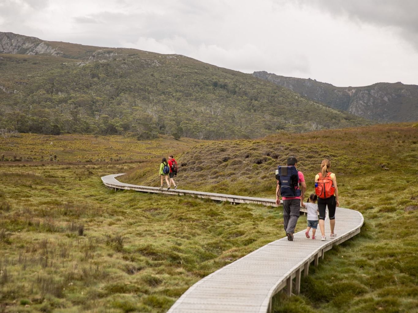 Family walking towards the mountain near Cradle Mountain Hotel 