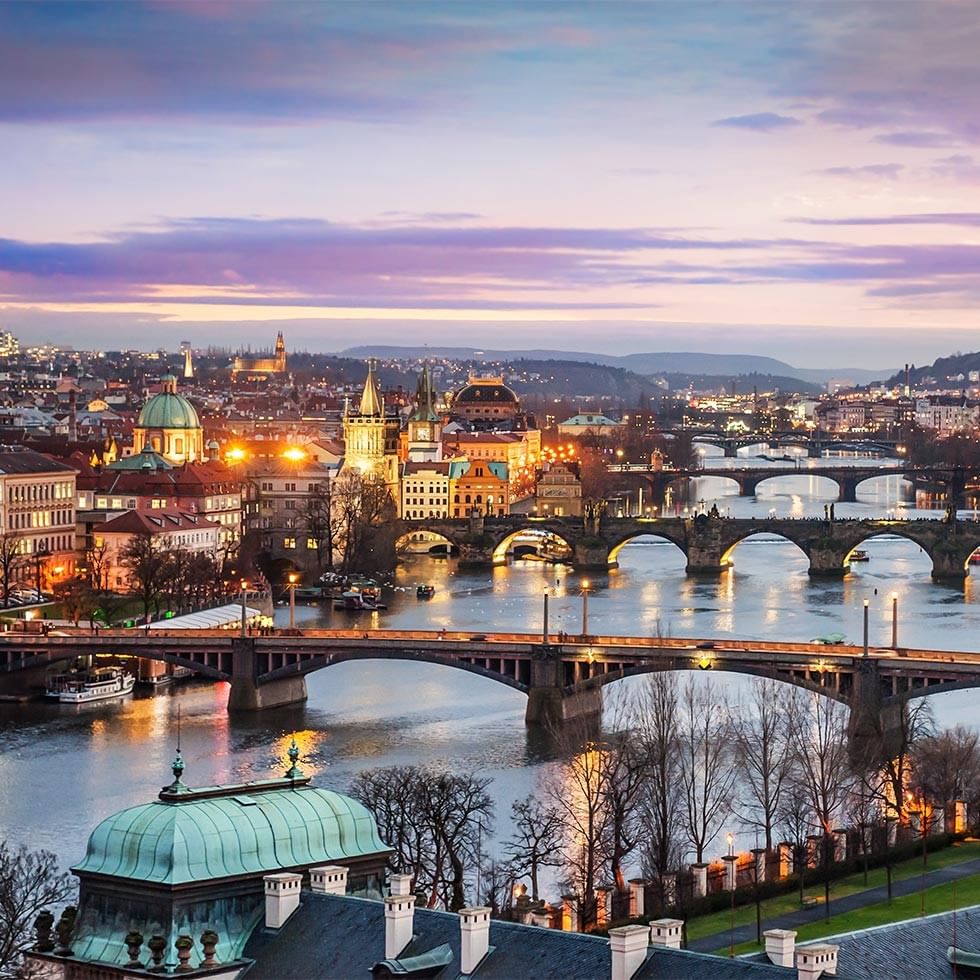 Scenic cityscape with bridges over a river at dusk in the events module.