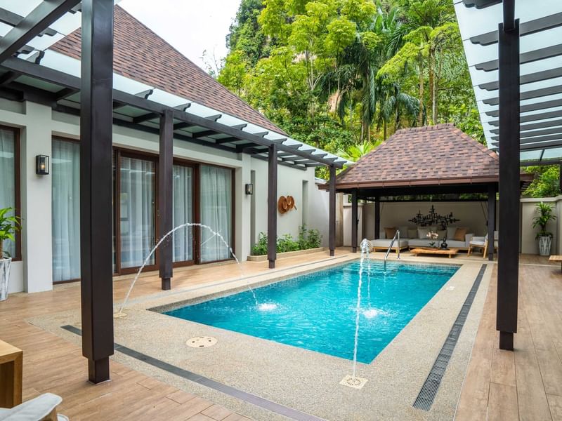 Private pool villa, wooden deck, pergola, lounge chairs, and lush tropical greenery surrounding the space promoting The Banjaran stay package
