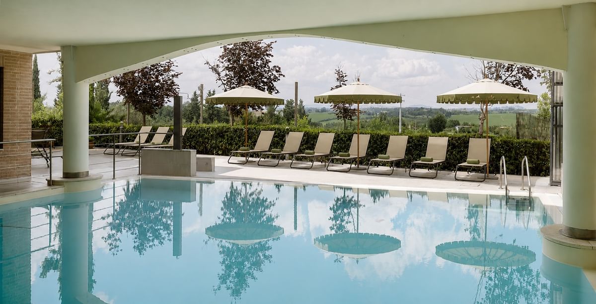 Pool and sun loungers overlooking the Tuscan hills