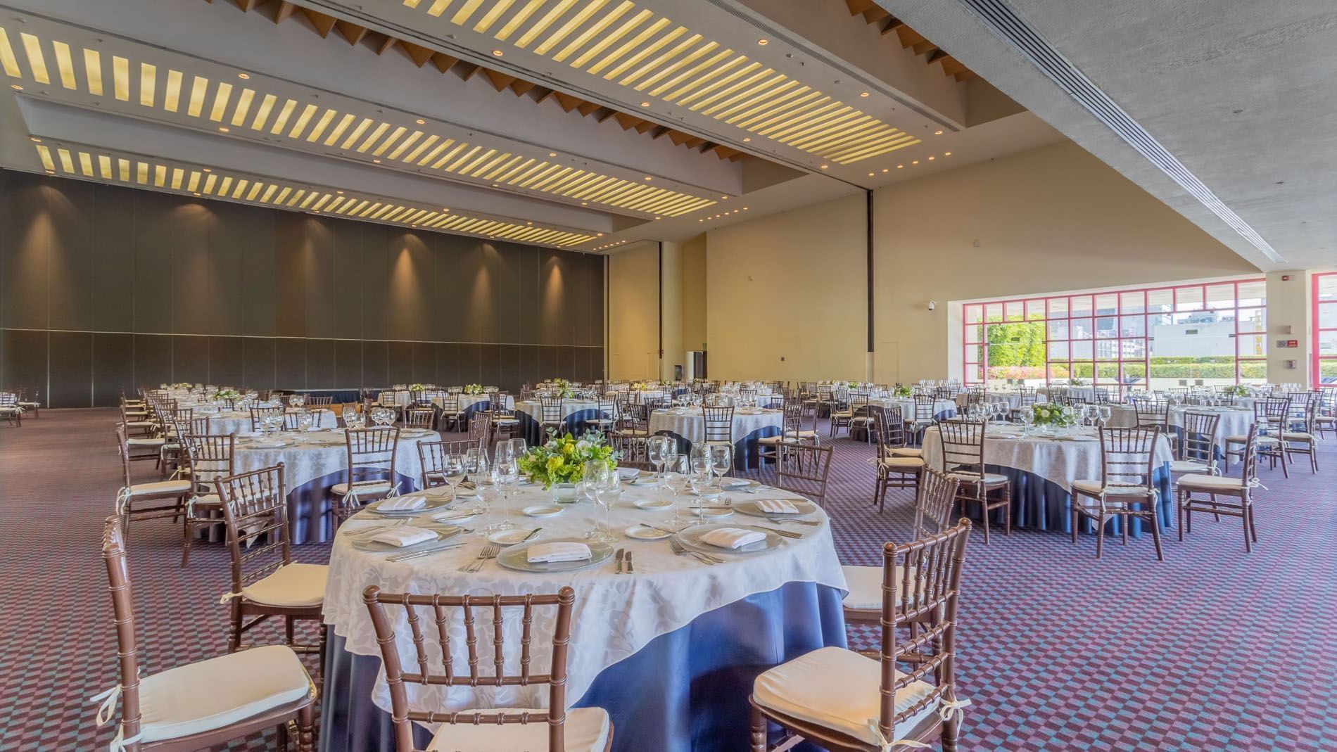 Molino B banquet hall at Camino Real Polanco Mexico, with blue tablecloths, floral centerpieces, and warm lighting