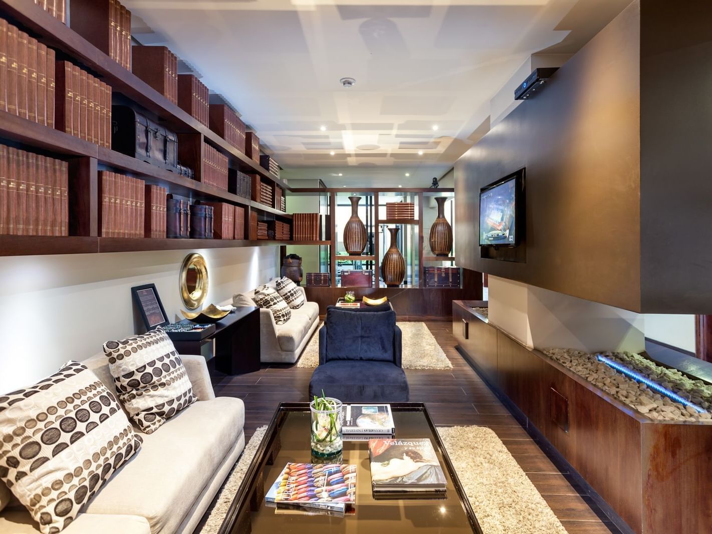 A lounge area with a TV in the hotel lobby at Blue Doors Hotels