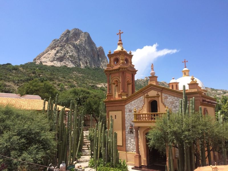 Peña de Bernal with a mountain near Fiesta Americana