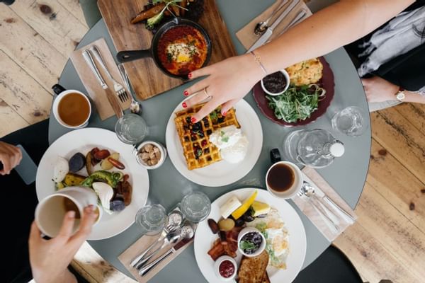 Aerial shot of table with breakfast food and waffles