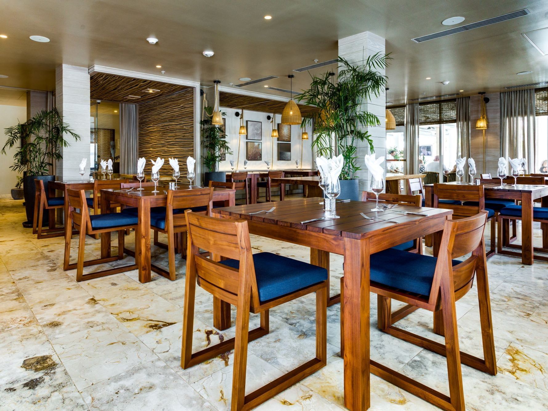 Dining tables arranged in Sea Salt at Alaia Belize Autograph Collection