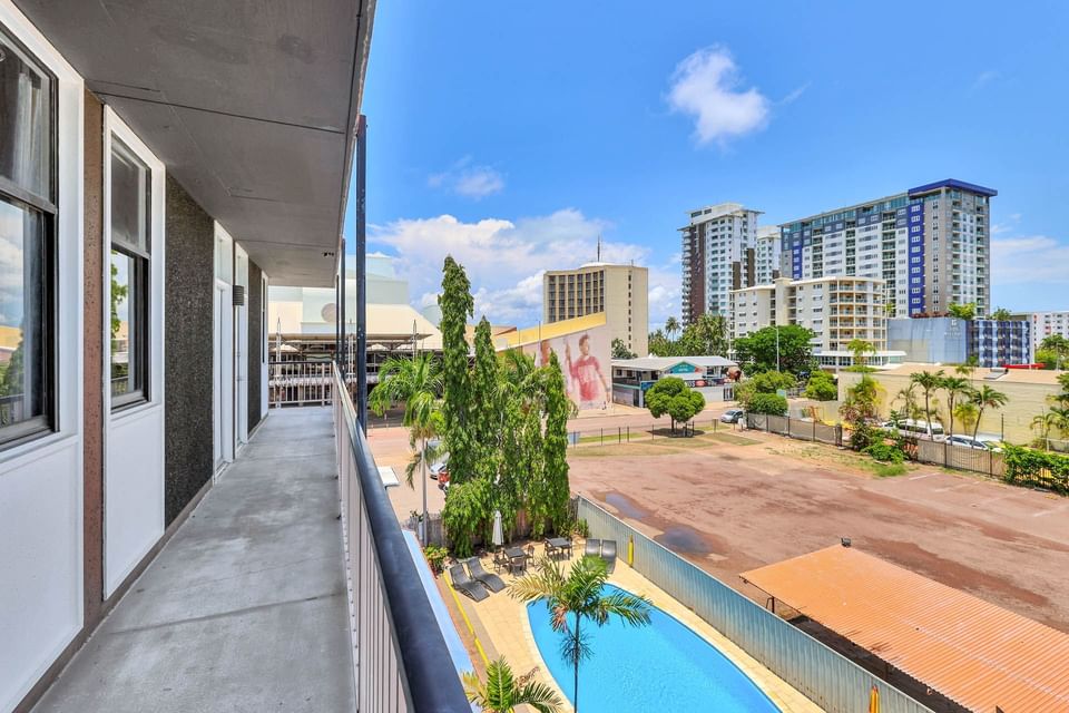 Balcony with a pool below and city view at Darwin Poinciana Inn