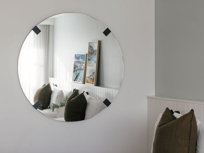 Village Terrace Twin at Elysium Manly with a round mirror reflecting framed art, olive pillows, best places to stay in Manly