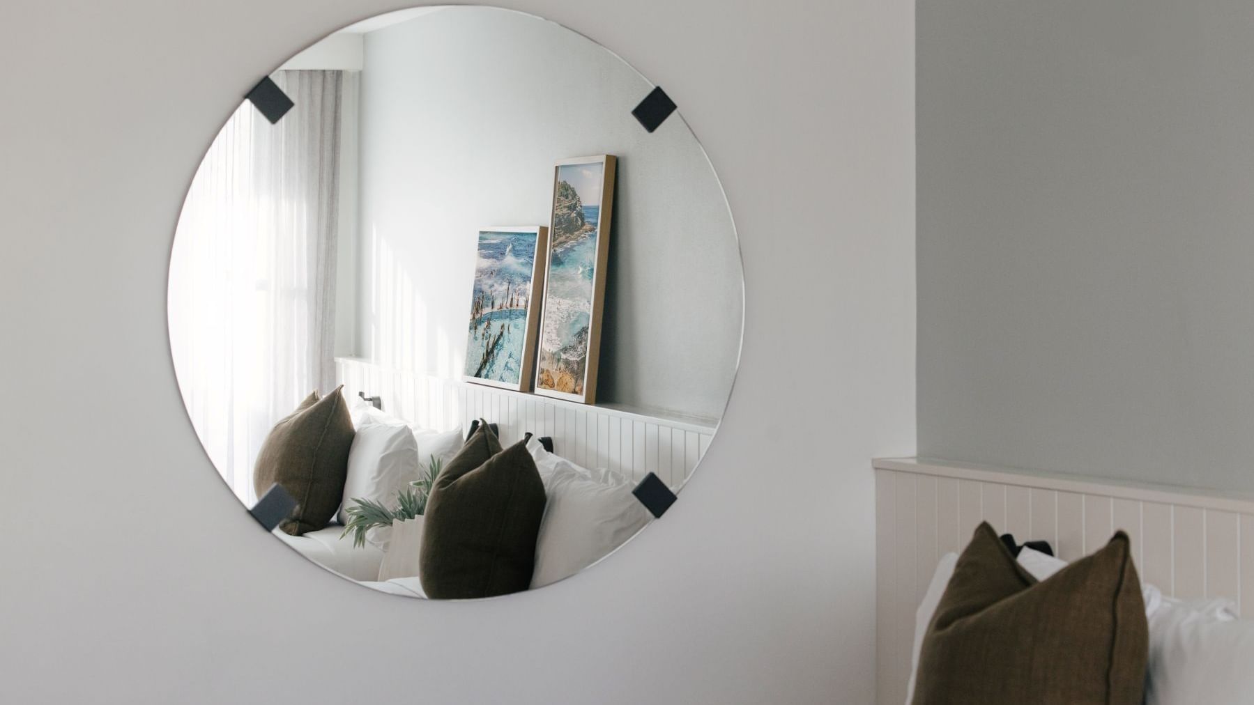 Village Terrace Twin at Elysium Manly with a round mirror reflecting framed art, olive pillows, best places to stay in Manly