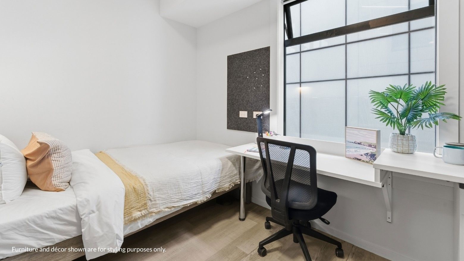 Clean student room with bed, desk, chair, and window at Mayoral Drive Student Accommodation.