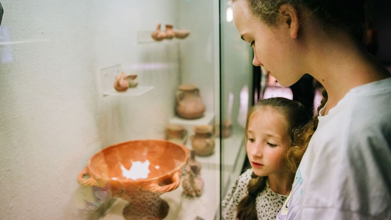 Two children looking at a historic craft in a museum