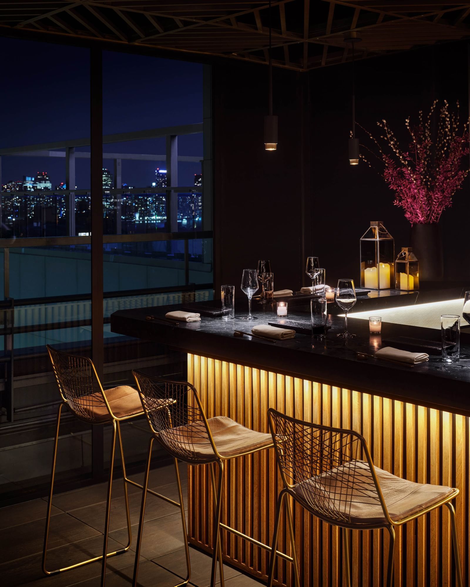 Saishin rooftop restaurant with high-top chairs and a floral arrangement