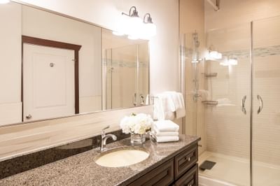 Bathroom with vanity & shower area in Apartment 203B at Retro Suites Hotel