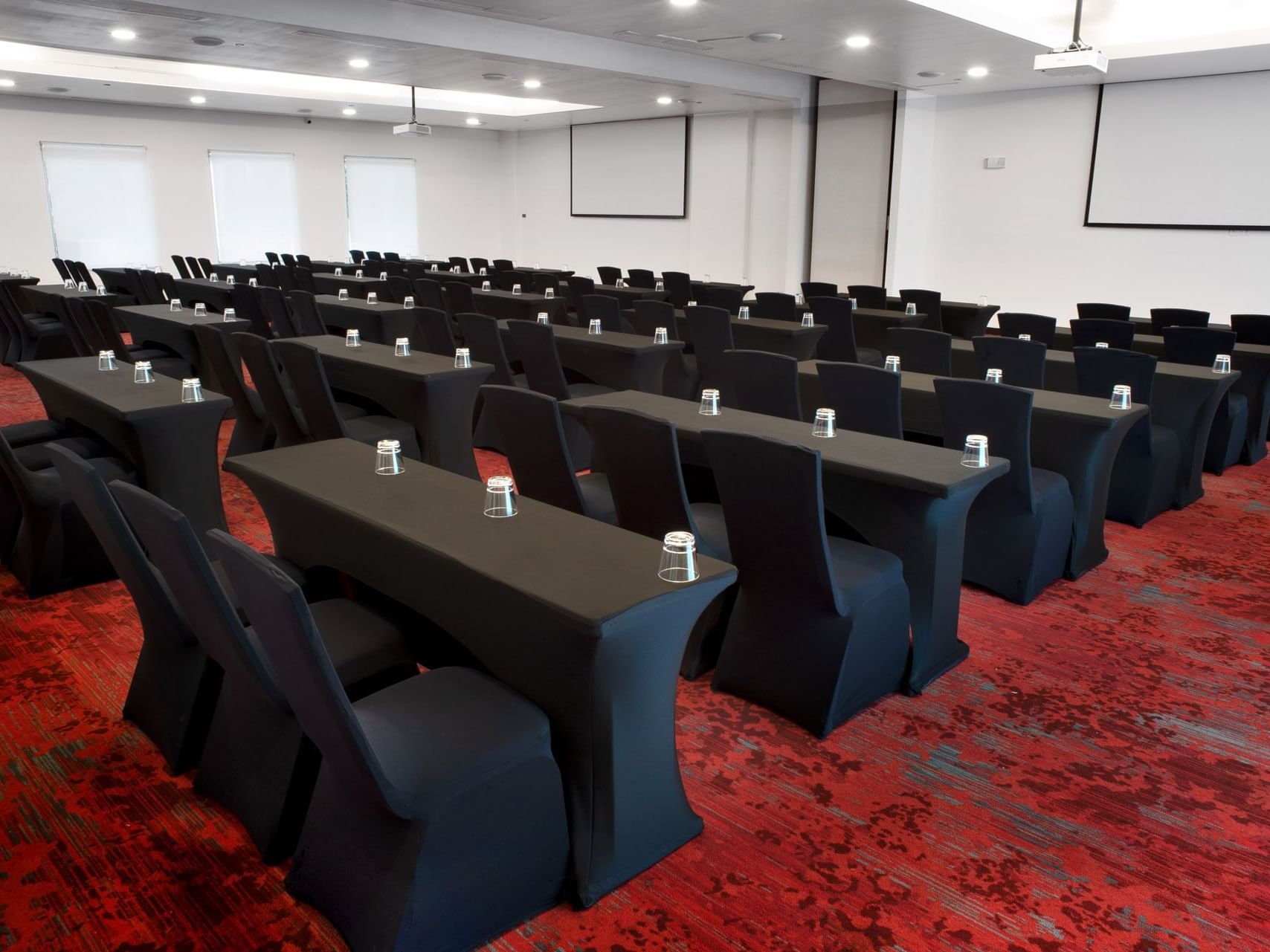 U-shape table with chairs and project screen in Aqua Room one of event space in San Jose Costa Rica at D Sabana Hotel