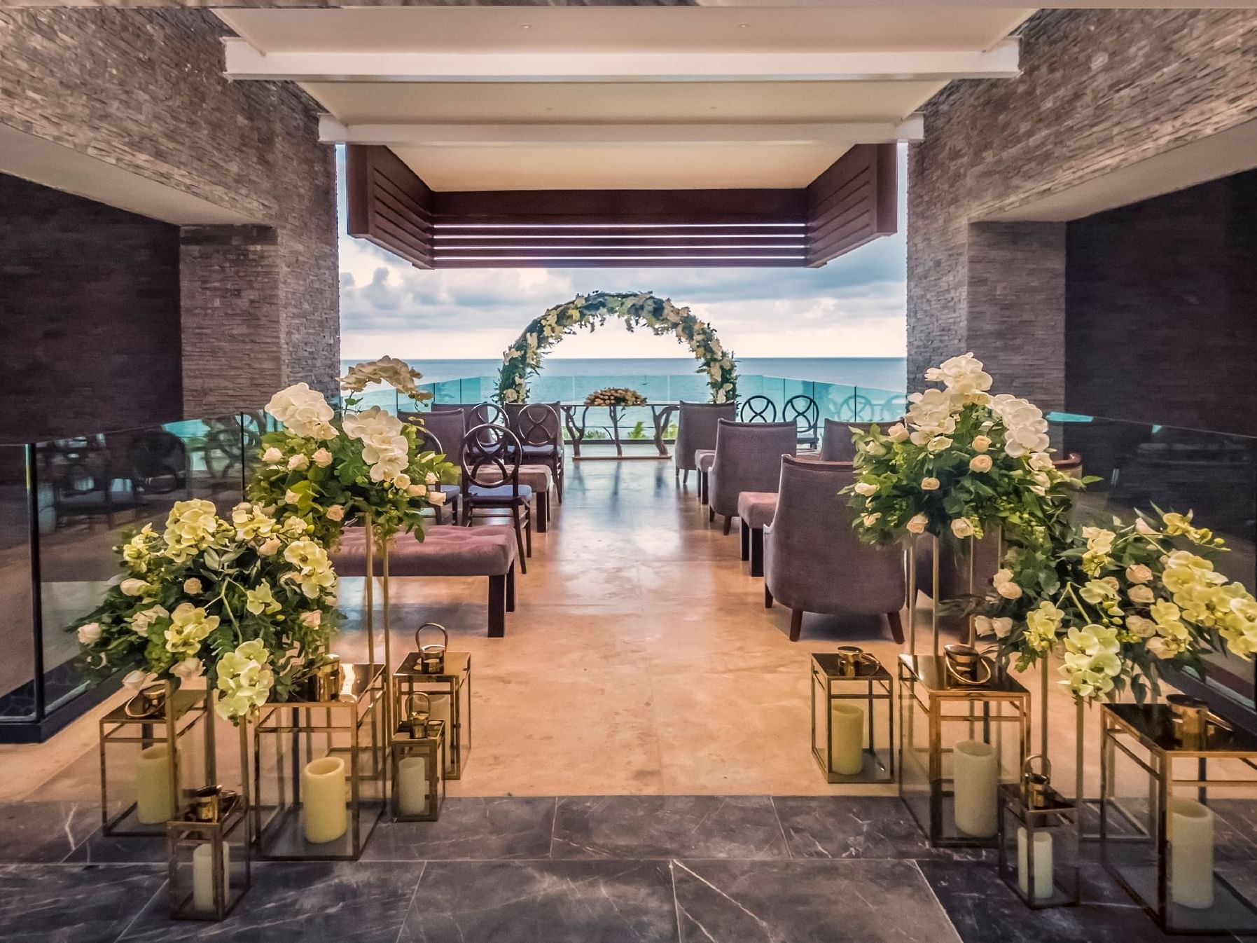 Wedding reception hall decorated with fresh white flowers & candles at Haven Riviera Cancun