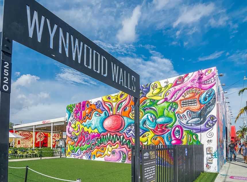 Wynwood Walls street sign with colorful murals at 27 Wynwood.