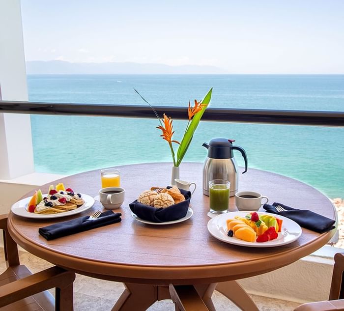 Breakfast table served with pancakes and fruits at Plaza Pelicanos Grand Beach Resort