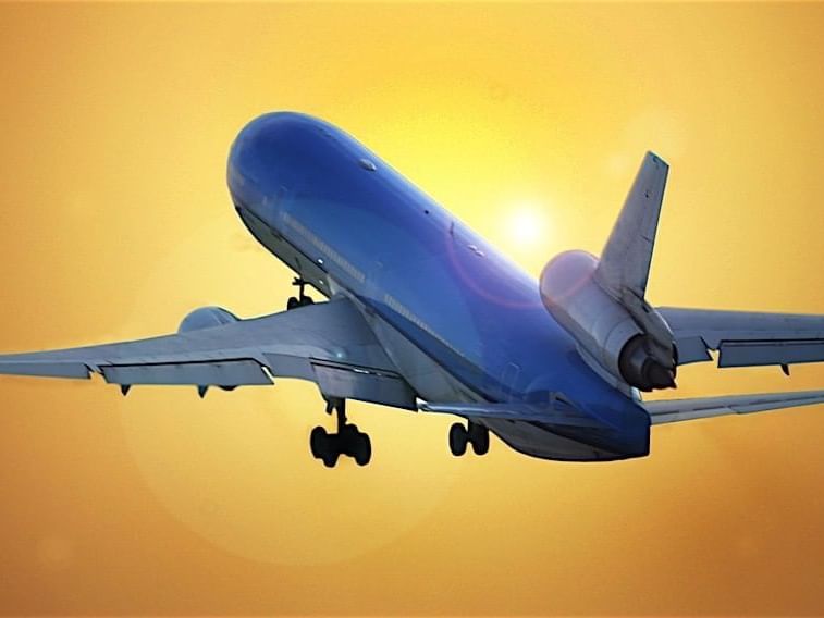 airplane taking off into yellow sky