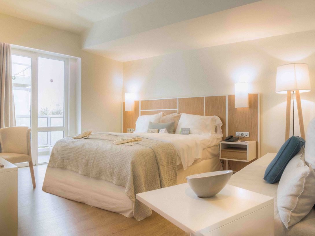 A king size bed in Eco Chic Room at St. George Lycabettus