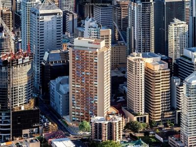 Aerial view of UniLodge Brisbane City among other tall buildings in urban area.