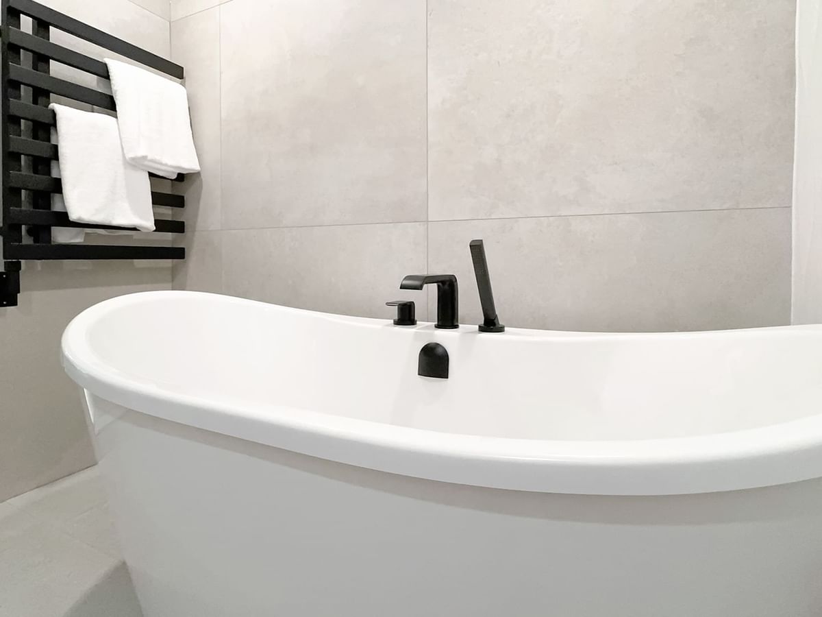 Hotel washroom with hotel bathtub and towels