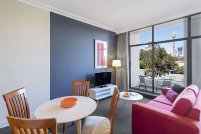 Living area with city view in Studio Apartment at Nesuto Hotels