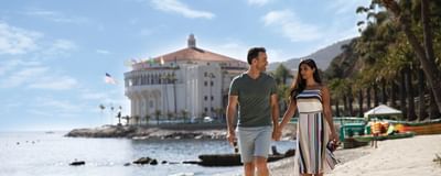 Couple strolling on the sunny beach at Catalina Island Company