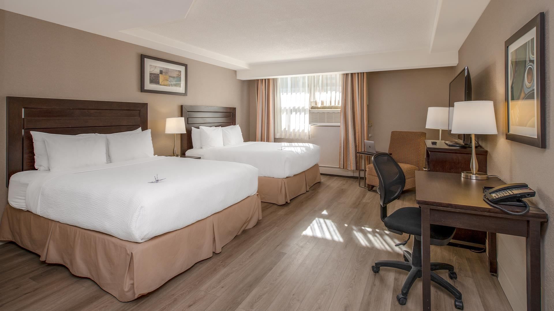 Hotel room with two queen beds and a work desk
