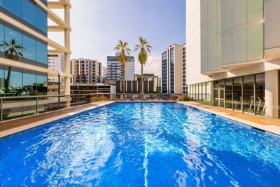 Outdoor pool area with exterior of Amora Hotel Brisbane